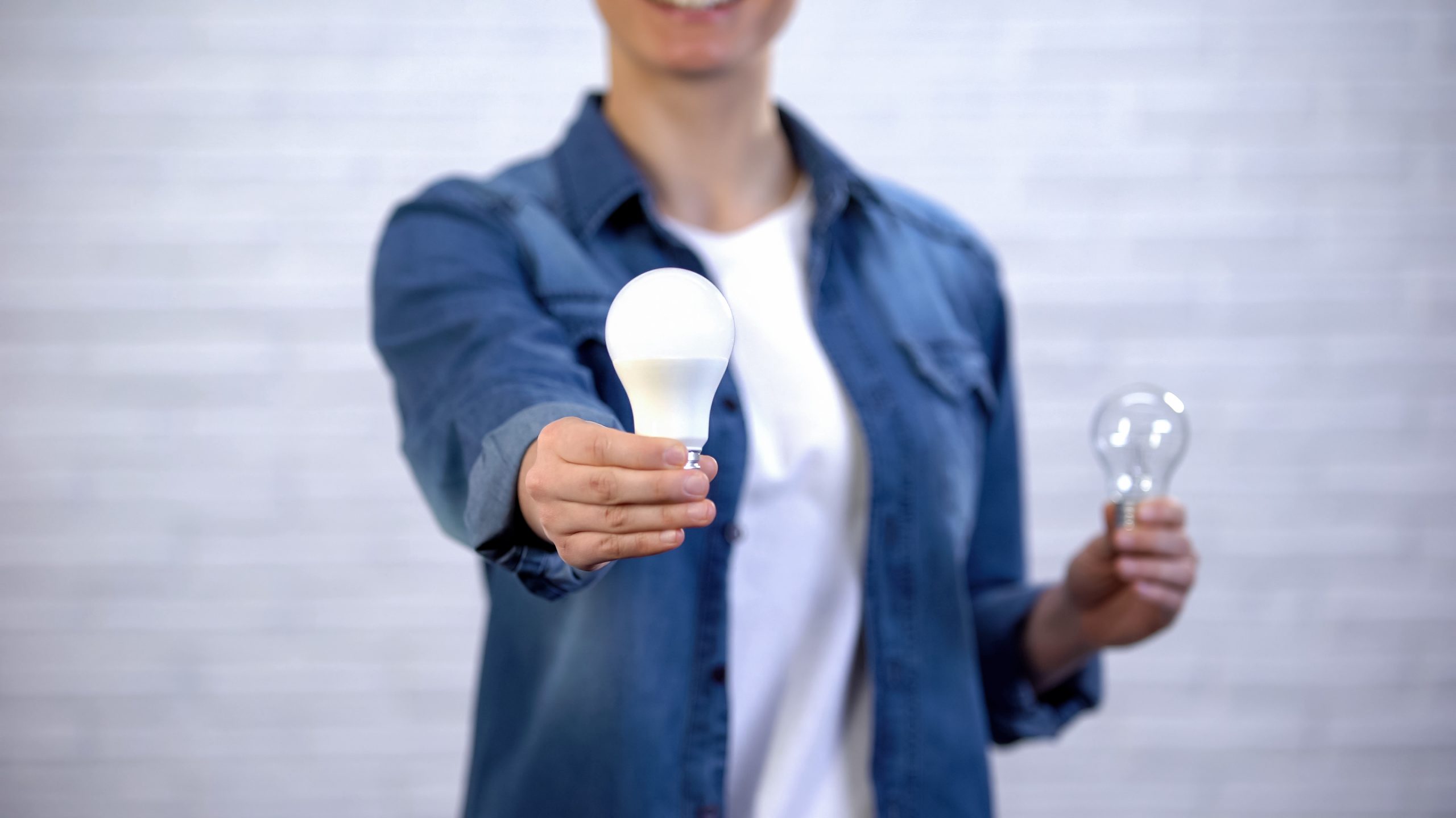 Women with LED and Incandescent Bulbs